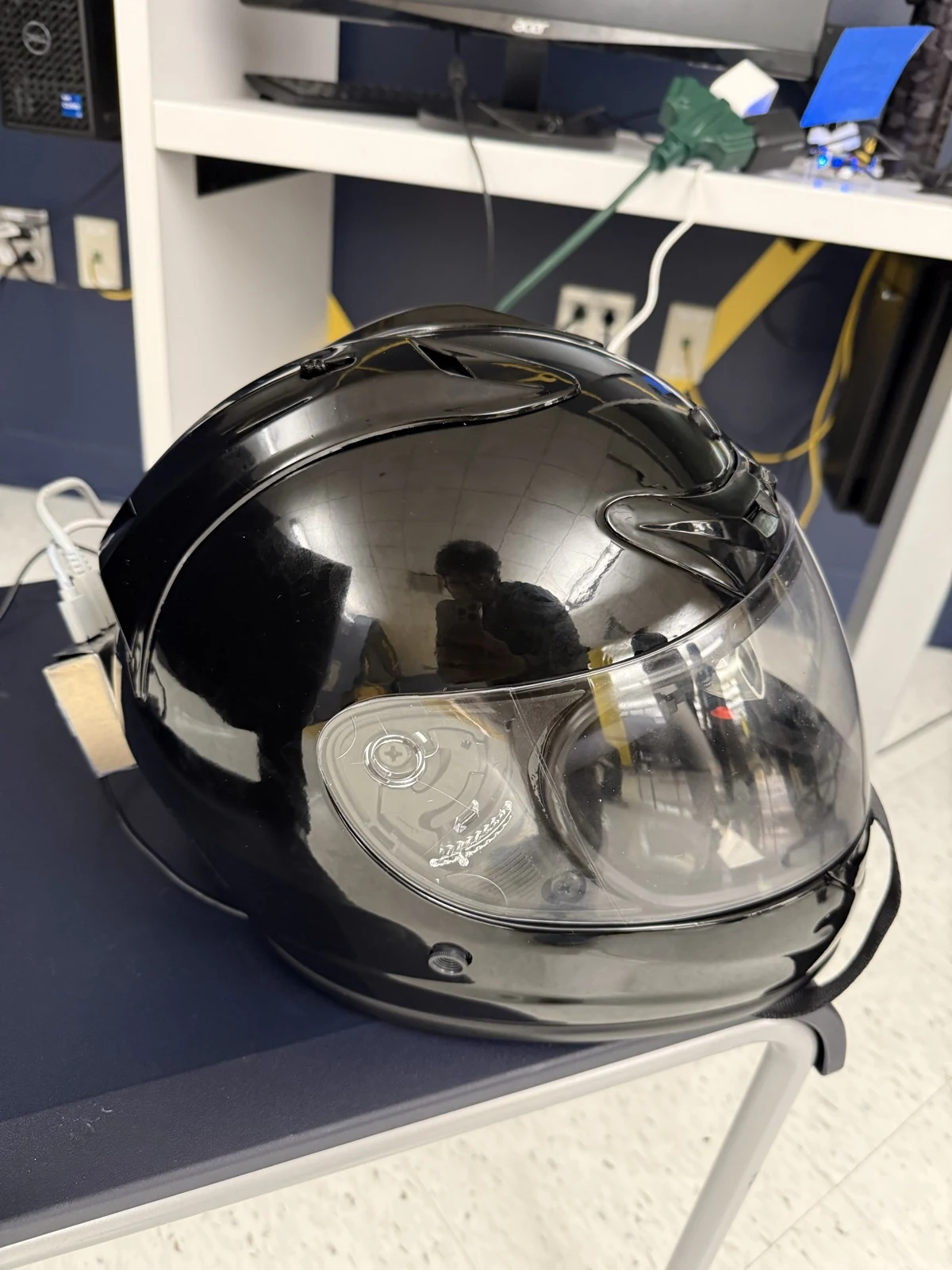 Side view of the helmet with the visor down and attached hardware visible at the rear